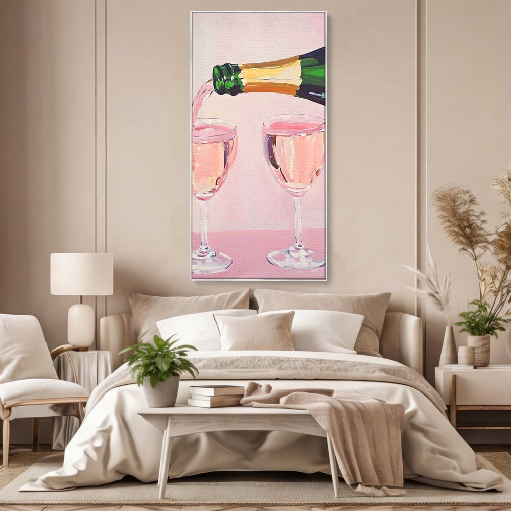 Tablou canvas cu pictura cu sticla si pahare de sampanie roz, in rama de aluminiu argintiu, pe perete intr-un dormitor